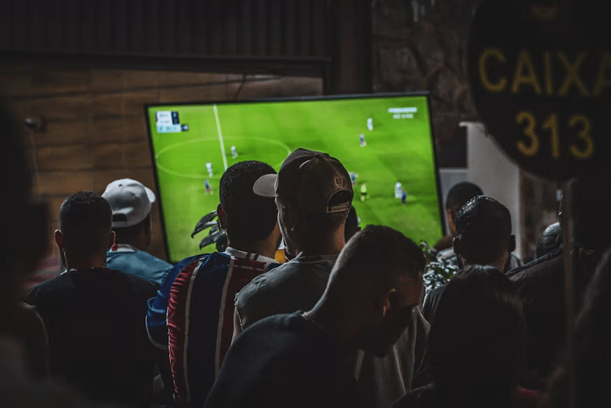 Person comparing different commentary languages while watching a football game.