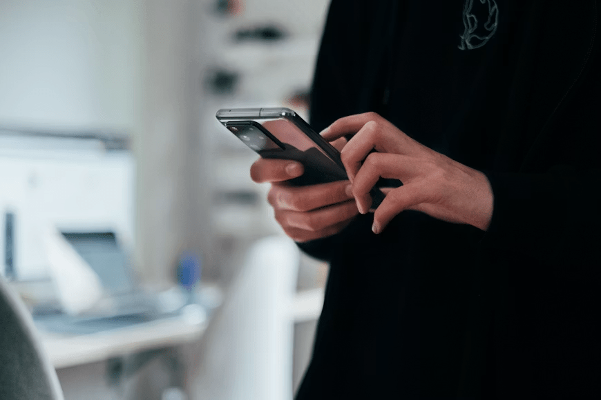 Person comparing two webtoon platforms on a smartphone before switching accounts.